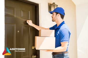 Man with boxes at front door-ecommerce packaging from a packaging company near me